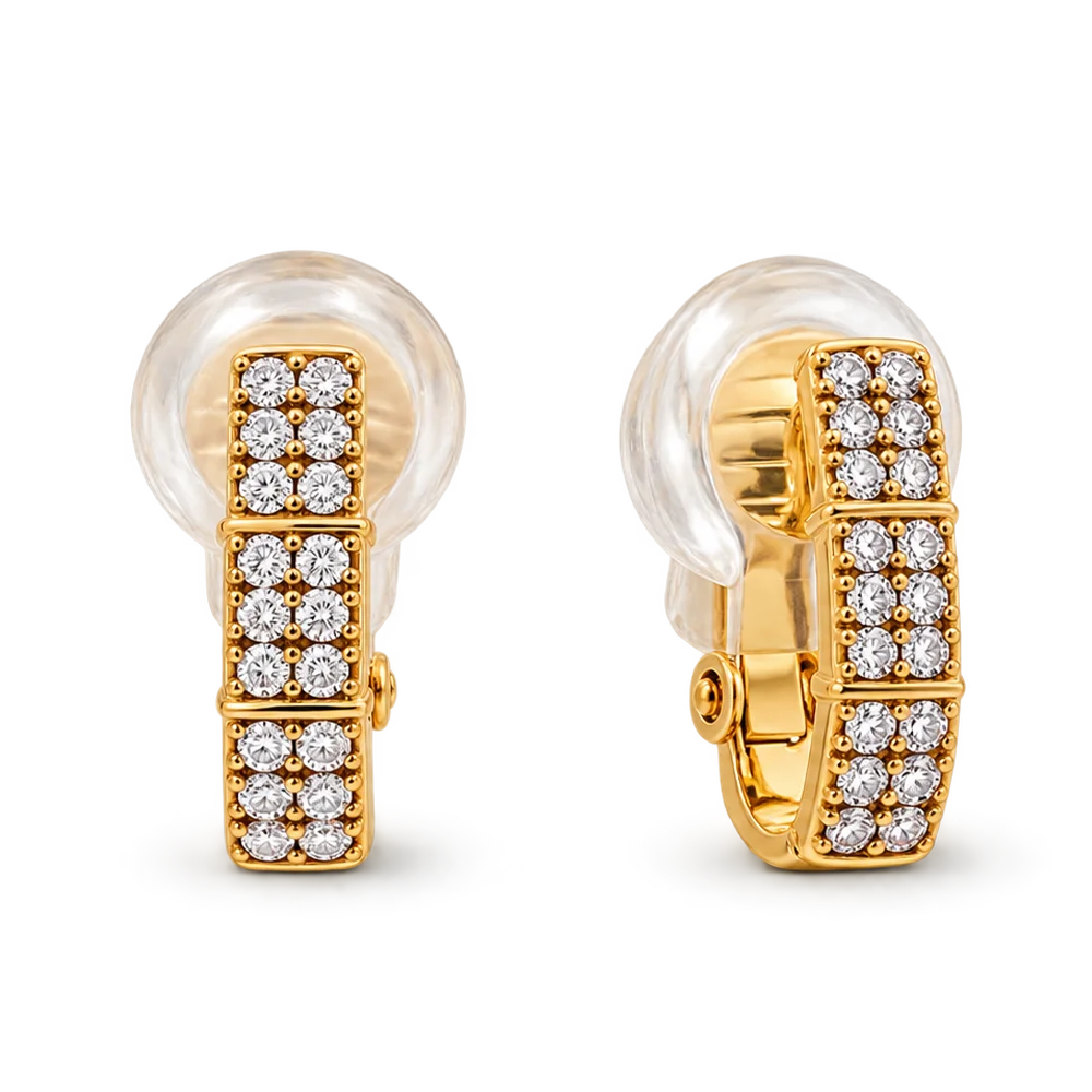 A pair of gold huggie earrings with clear crystal pavé settings, shown on a clean white background.
