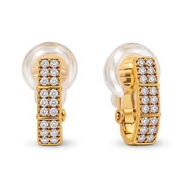 A pair of gold huggie earrings with clear crystal pavé settings, shown on a clean white background.