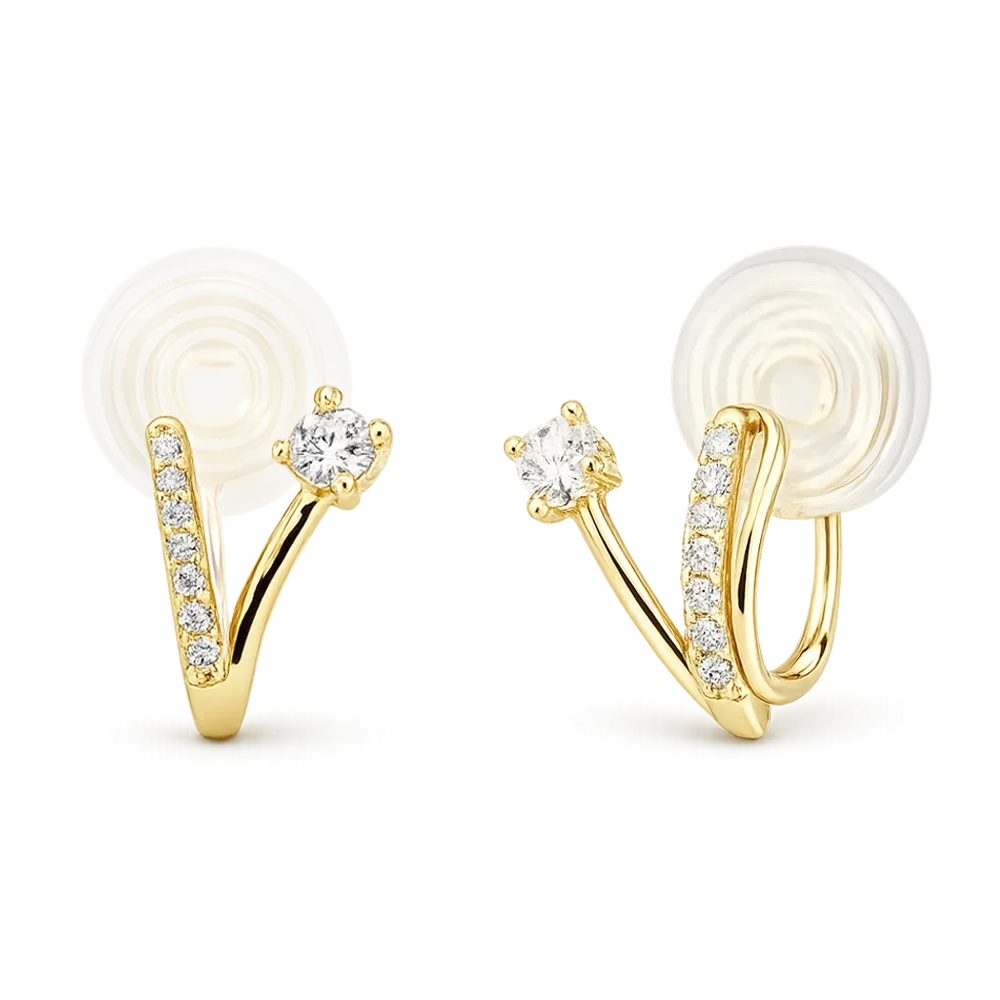 A pair of gold hoop earrings with clear gemstones, shown on a plain white background. Each earring features a curved gold band with a row of small clear stones and a larger central clear stone, attached to a flat circular white backing.