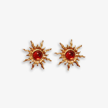 Gold sun clip-on ear studs with red faux rubies adding fiery power.
