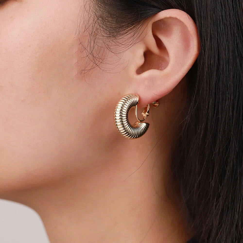 Gold helix hoop clip-on earrings side view worn on ear, textured twisted design