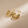 Channel-Set Zirconia Clip-On Hoop Earrings in gold with cubic zirconia stones, angled view on neutral background