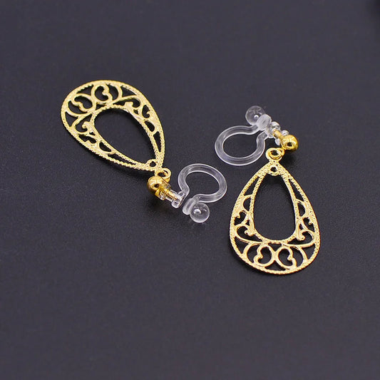 Close-up of Golden Filigree Teardrop Invisible Clip-On Earrings highlighting the delicate copper filigree pattern.
