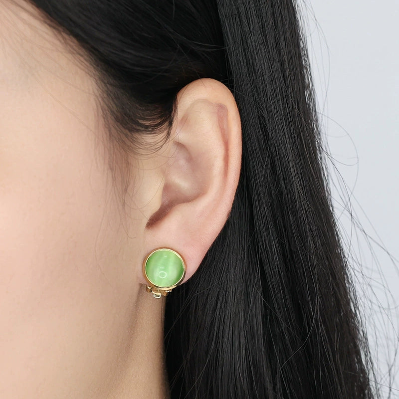 Golden Green Cat Eye Clip-On Stud Earrings side view on model with black hair