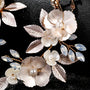 Golden Leaf & Blossom Clip-On Earrings with Pearls, overhead view featuring white floral petals, pearl centers, and blue crystal accents on black background.