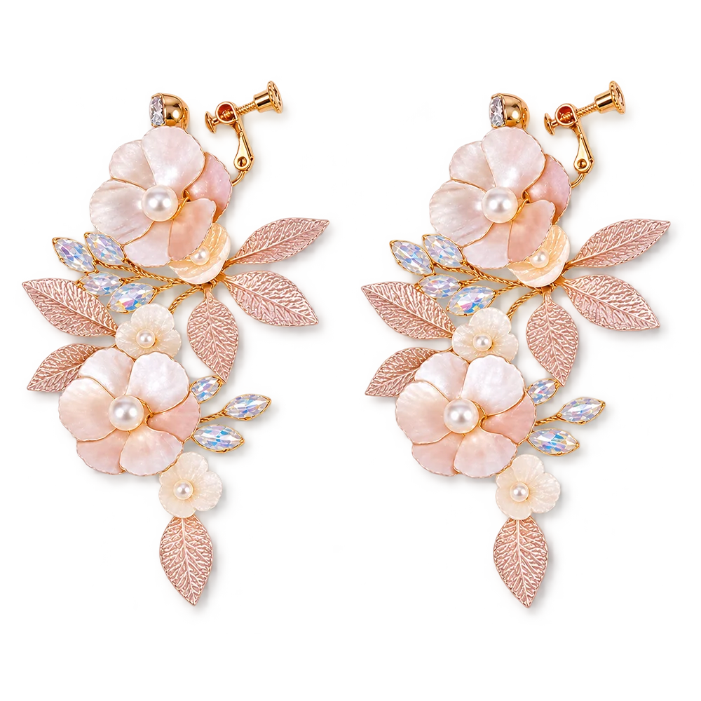 A pair of gold-tone floral drop earrings featuring large and small flower clusters with iridescent pearl-like centers, textured leaf details, and small faceted blue-green stones on a white background.