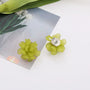 Green Flower Clip-On Earrings with silver metal tops displayed on white background with botanical styling