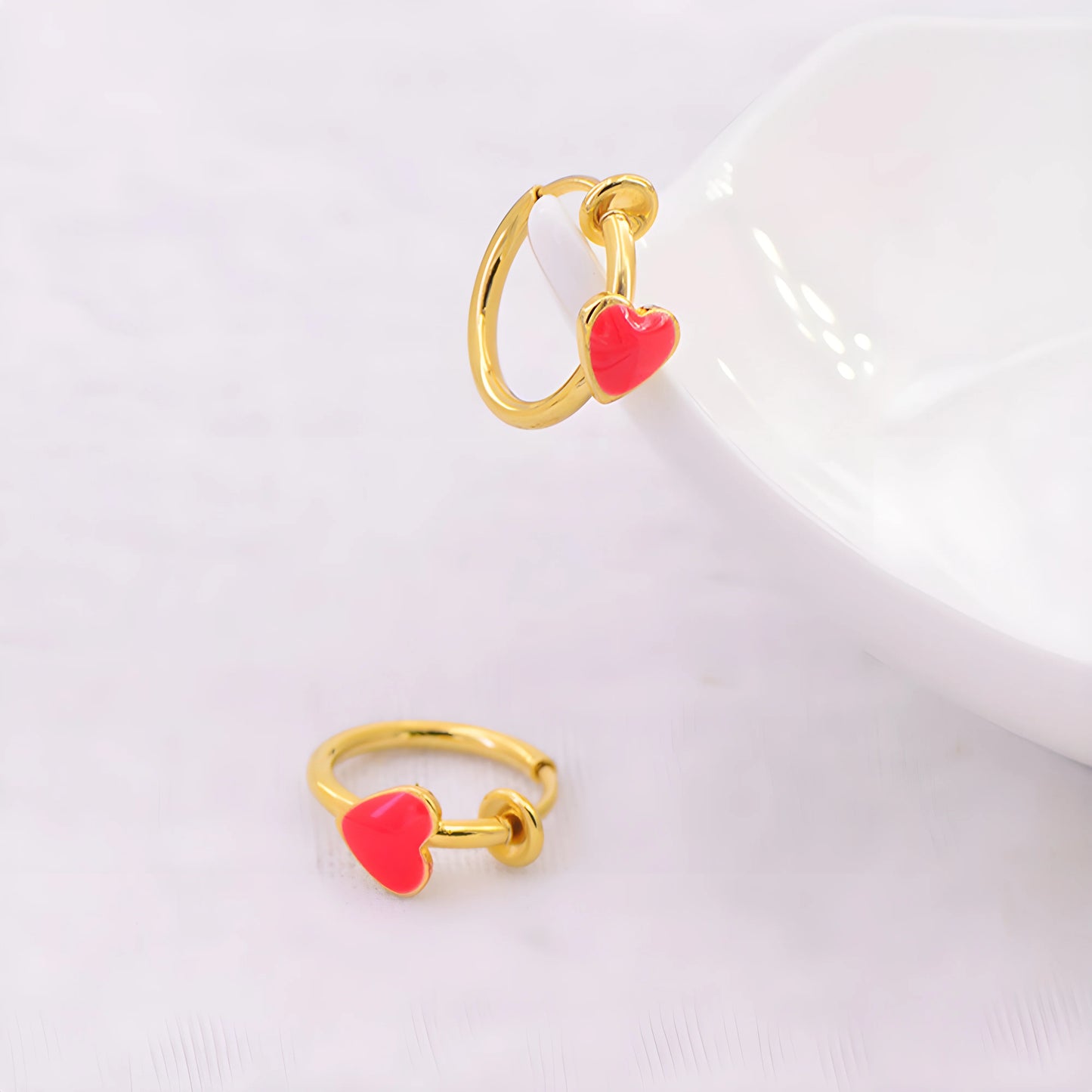 Stylish women's fake earrings in gold, perfect for any occasion.