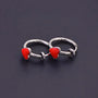 Detailed view of sliding spring-ring clip-on design on silver heart hoop earrings.