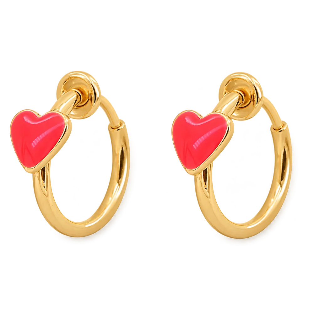 A pair of gold hoop earrings with a small, polished red heart charm attached to each hoop, shown against a plain white background.