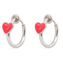 A pair of silver hoop earrings, each adorned with a small, glossy hot red heart charm, shown against a plain white background.
