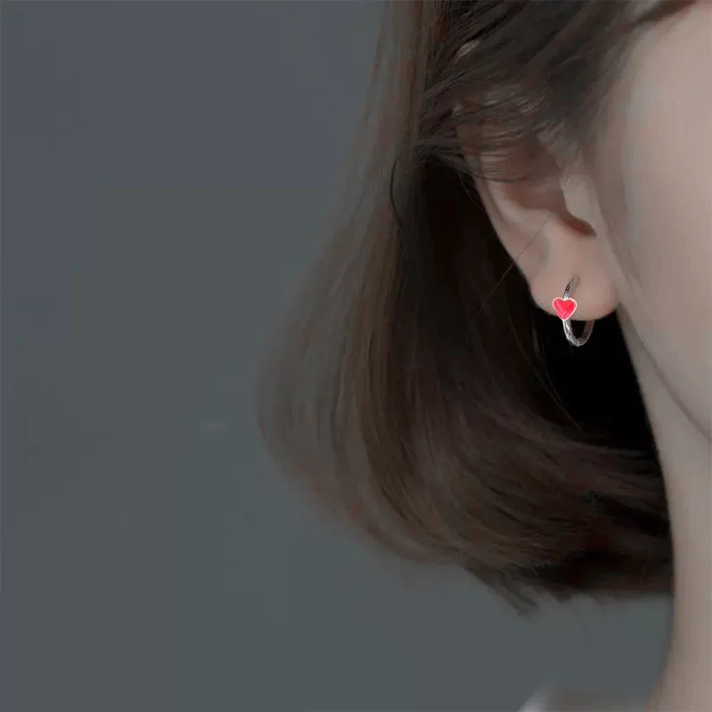 Model wearing Silver Heart Clip-On Hoop Earrings, showcasing a stylish and secure fit.