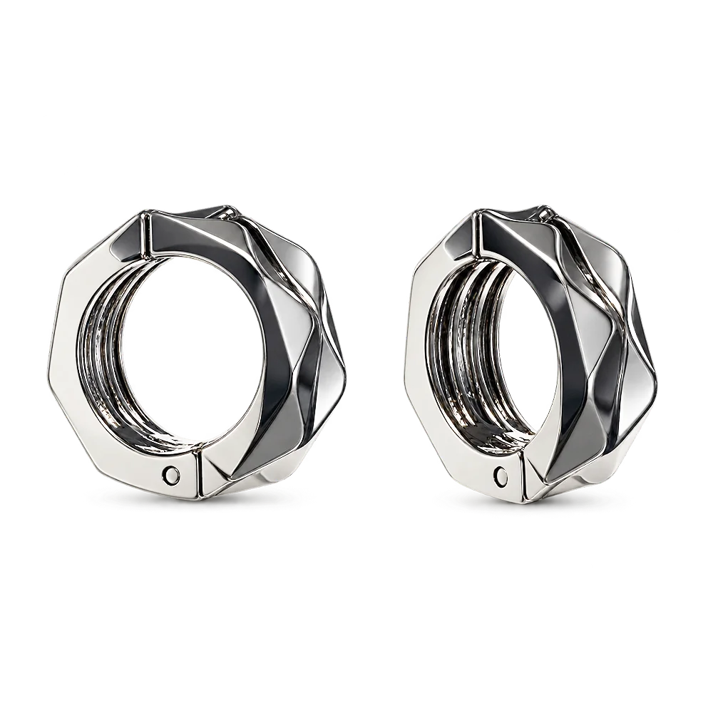 A pair of silver-toned geometric clip on hoop earrings with a faceted, multi-sided design, shown on a clean white background.