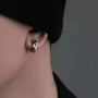 Hex Cut Clip-On Hoop Earrings in Black side view worn on ear, silver and black metallic finish