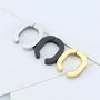 Horseshoe clip-on hoop earrings in silver, black, and gold displayed on white background