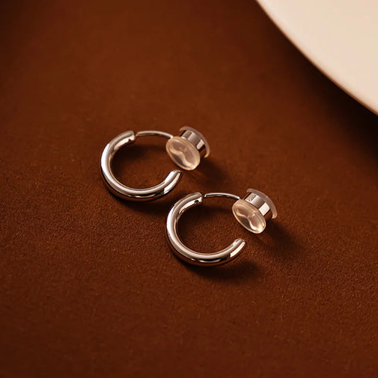 Showcase of Huggie Hoop Clip-On Earrings in White Gold, highlighting the sleek and elegant finish.