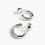 18K white-gold-plated huggie clip-on hoop earrings showing the polished cool-tone finish.