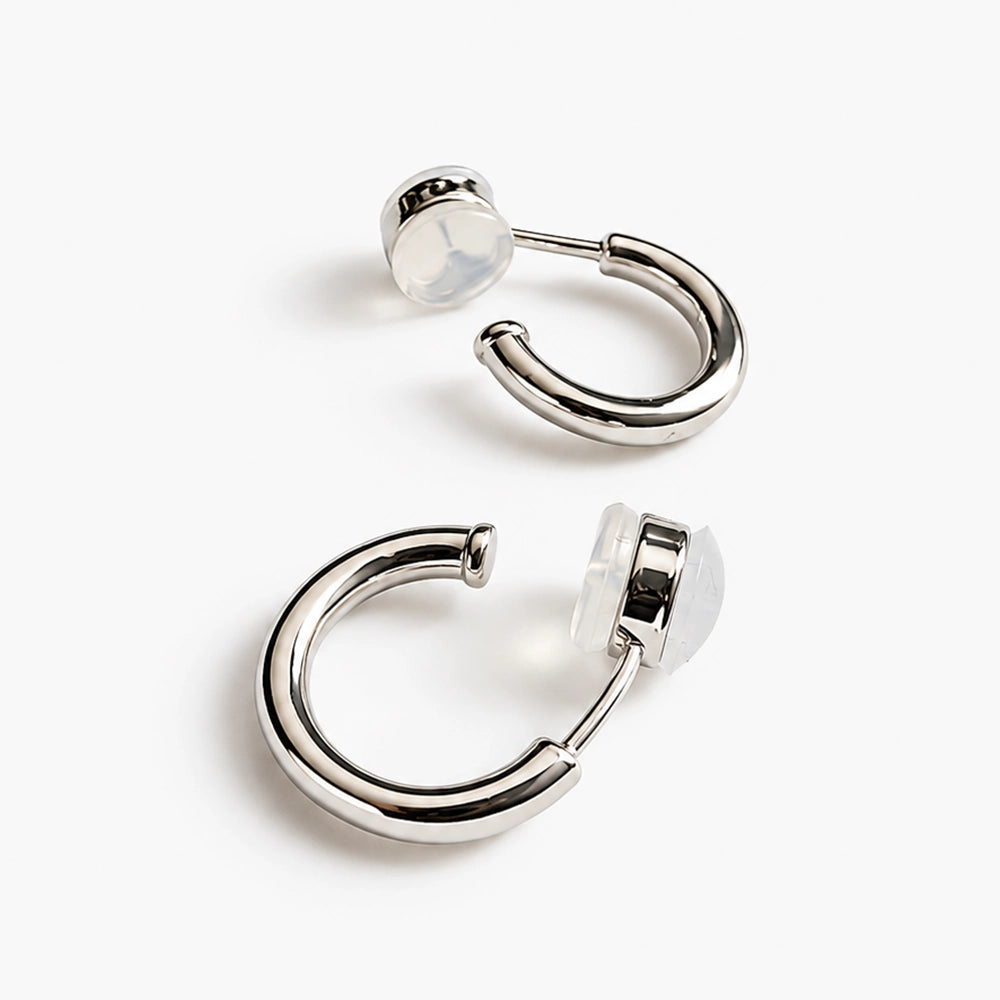 18K white-gold-plated huggie clip-on hoop earrings showing the polished cool-tone finish.
