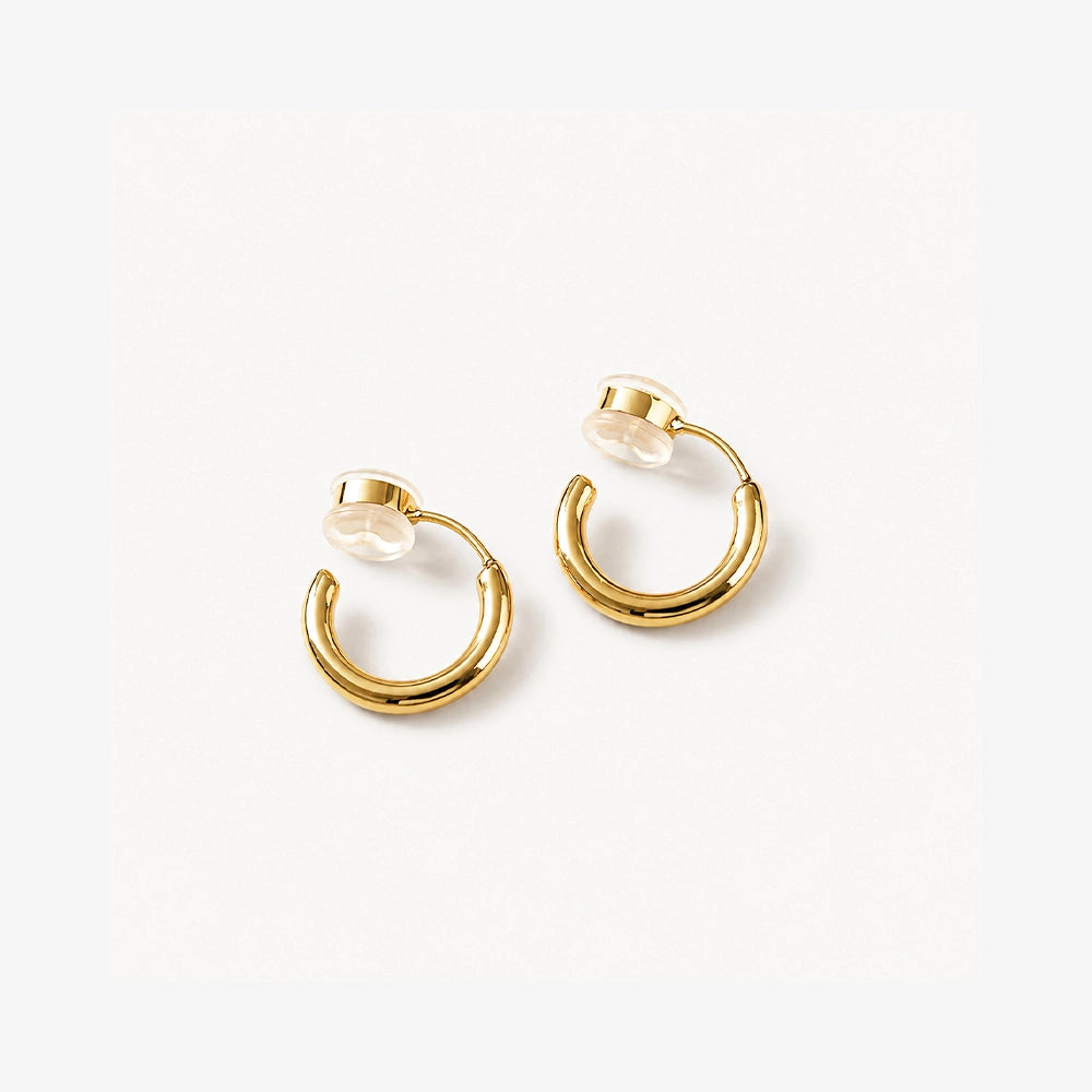 Gold hoop earrings centers on a white background
