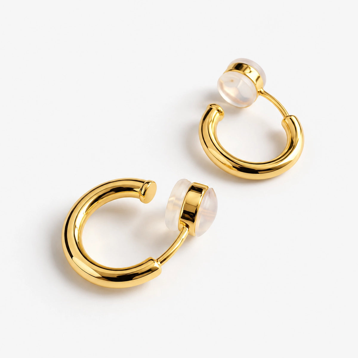 18K yellow gold-plated huggie hoop clip-on earrings centered on a white background.