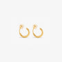 A pair of gold-colored clip-on huggie hoop earrings with a sleek, classic design.