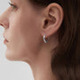 Model wearing 18K white-gold-plated huggie clip-on hoop earrings, showing the close-fitting C-Type design.