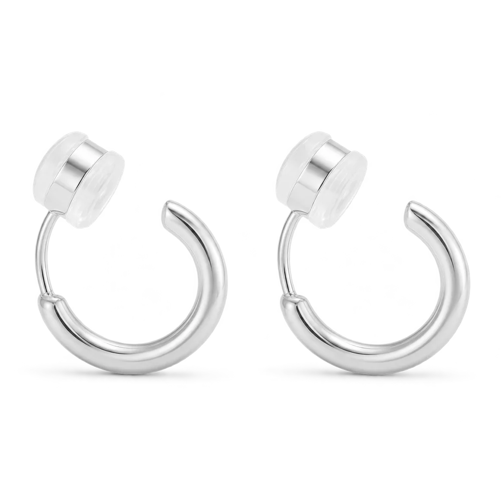 A pair of silver-toned curved hoop clip on earrings, shown on a clean white background.