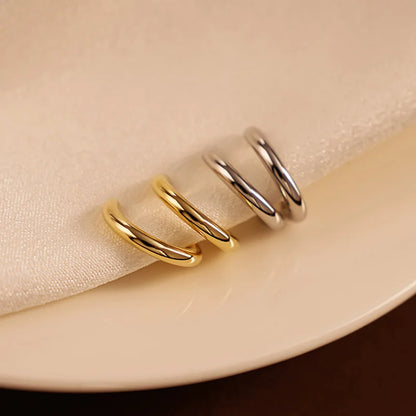 Showcase of Huggie Hoop Clip-On Earrings, highlighting the sleek and elegant finish.