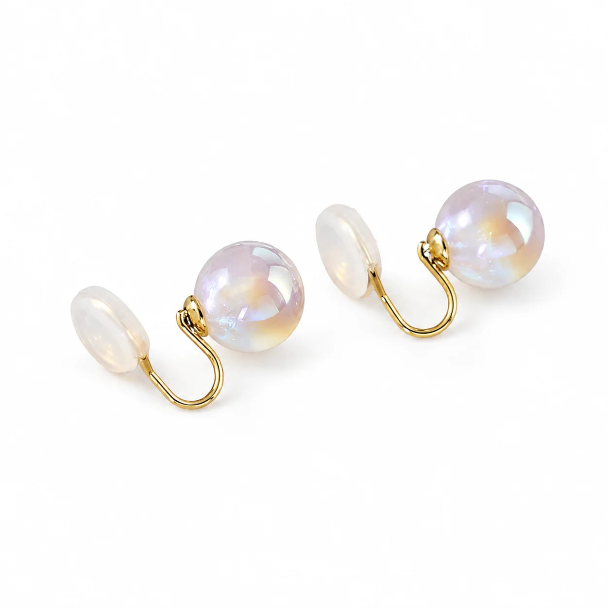 A pair of clip earrings with large, oval, iridescent pearl-like beads on a clean white background.