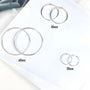 Silver large hoop clip-on earrings in three sizes displayed on white background