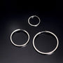 Silver large square tube clip-on hoop earrings displayed in three sizes on dark background