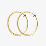 Large square tube clip-on hoop earrings in gold shown from front angle on white background