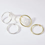 Large twisted textured hoop clip-on earrings in silver and gold displayed on white background showing product details