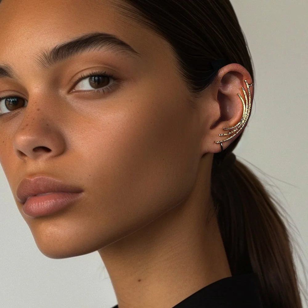 Gold linear contour ear climber on model, side profile view showing curved design on ear