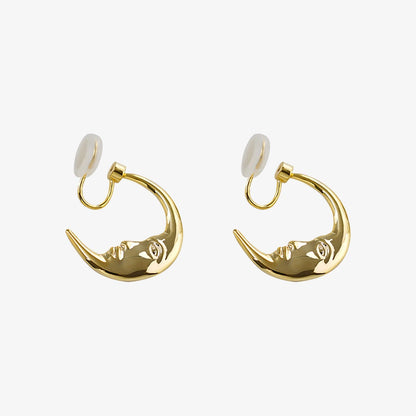 Front view of Lunar Face Gold Rotating Clip-On Earrings highlighting the crescent moon design.