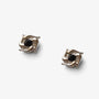 A pair of magnetic silver-toned square stud earrings with a central round black gemstone, displayed on a white surface