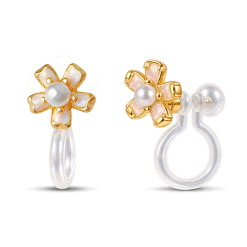 A pair of gold flower-shaped clip on earrings with white pearl centers and iridescent white petal inlays, shown on a clean white background with one earring facing forward and the other showing the side profile.