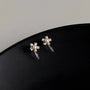 Mini Pearl Flower Invisible Clip-On Stud Earrings displayed on black surface, showing delicate silver-tone floral design with pearl centers