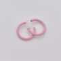 Pink mini glow clip-on hoop earrings displayed at angle on white background