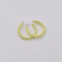 Yellow mini glow clip-on hoop earrings displayed on white background, front view showing translucent resin material