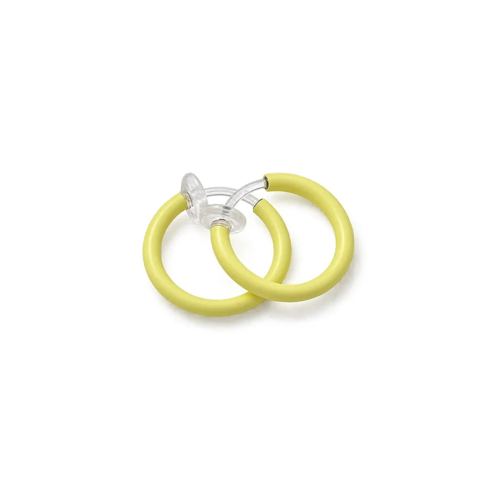 Two soft yellow glow-in-the-dark clip on earrings, shown on a plain white background.