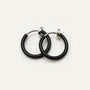 Black mini hoop clip-on earrings with silver-tone findings displayed on white background