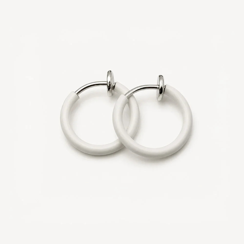 White mini hoop clip on earrings front view on neutral background, featuring silver-tone hardware and glossy finish