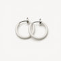 White mini hoop clip on earrings front view on neutral background, featuring silver-tone hardware and glossy finish