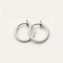 White mini hoop clip on earrings front view on neutral background, featuring silver-tone hardware and glossy finish