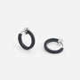 Close-up of Black Mini Square Tube Clip-On Hoop Earrings showcasing the edgy and sleek black enamel plating.