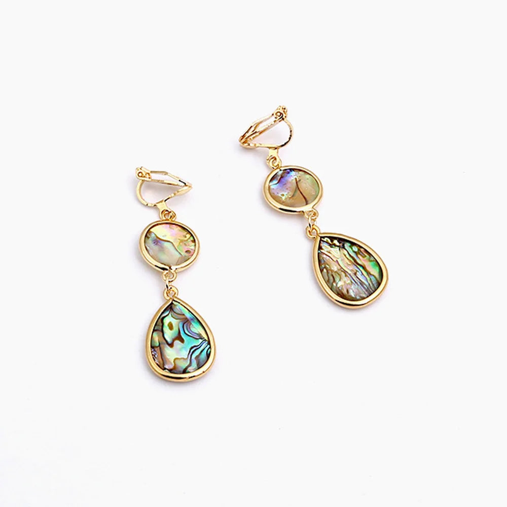 Gold abalone shell teardrop clip-on earrings with iridescent multi-colored shells on white background