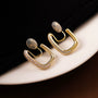 Pavé Square Gold Clip-On Hoop Earrings displayed at an angle on white background showing crystal detail and gold finish