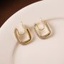 Pavé square gold clip-on hoop earrings with diamond accents displayed on white background, front view