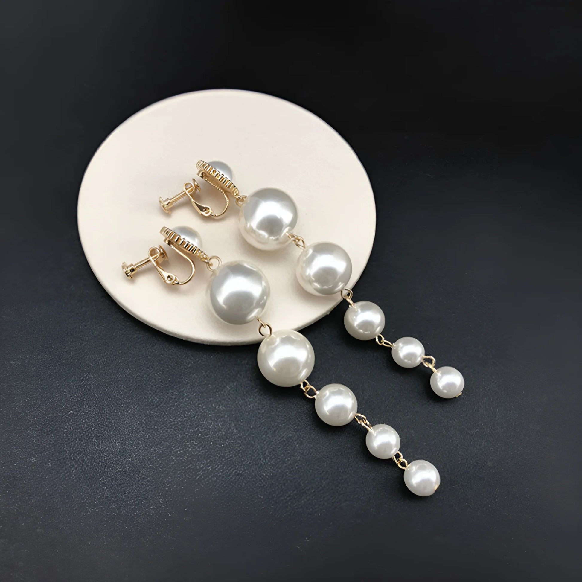 Bridal model showcasing clip on bridal earrings, featuring a cascading pearl design, perfect for formal occasions.